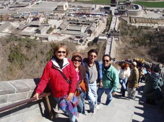 Friends enjoy a hike together while ascending ancient steps at a well-known historic location.