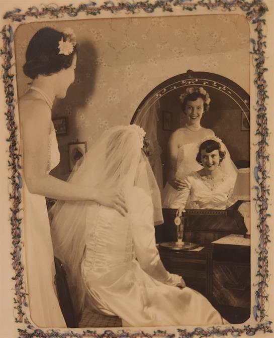 A bride and her friend share a heartfelt moment while getting ready for the wedding.