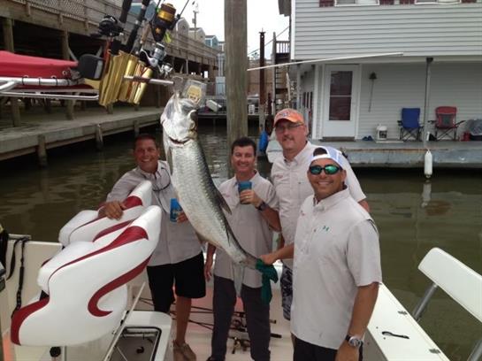 A group of men holding a fish