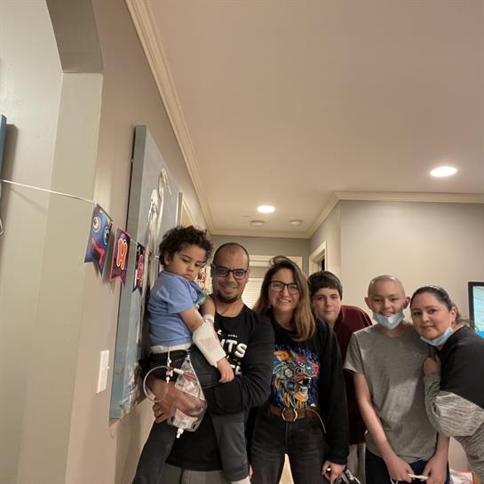 A happy family poses in a warm hallway, sharing smiles and laughter together.