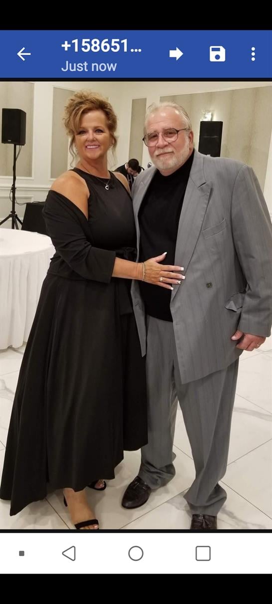 A man and woman posing for a picture