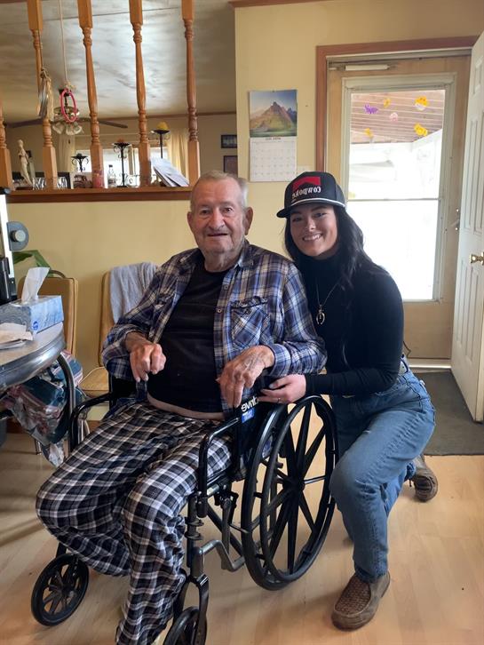 A man in a wheelchair with a woman in a room