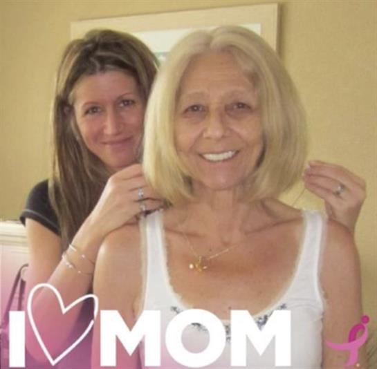 A daughter lovingly adjusts her mother's hair while they share a joyful moment together.