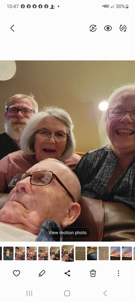 Four family members share a delightful moment together in a warm and inviting living room.