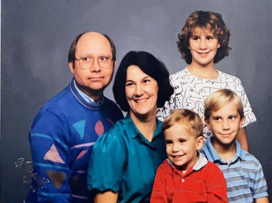 A family photo of a man woman and children