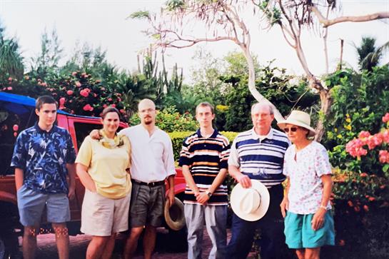 A group of people standing in front of a red truck