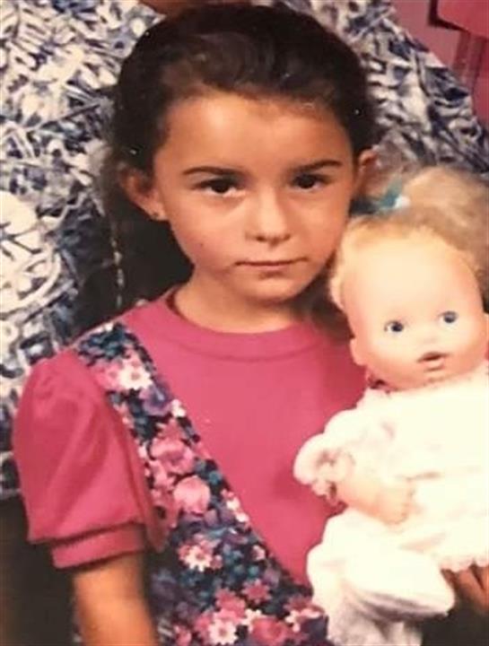 A girl holding a doll
