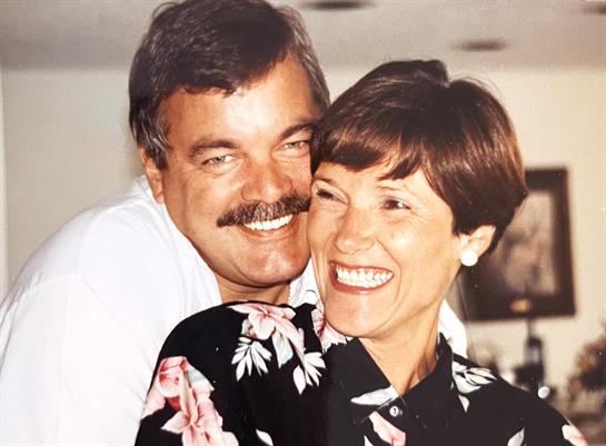 A man and woman smiling