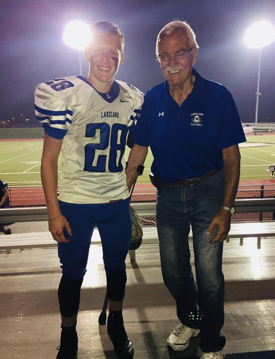 A man and a boy standing together