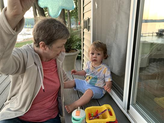 A woman and child sitting on a porch