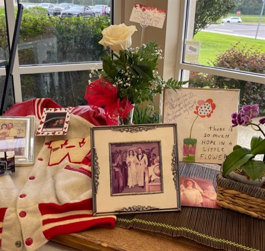A group of pictures and flowers on a table