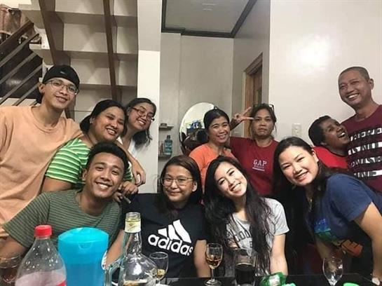 Friends gather at home for drinks, laughter, and good times late into the night.