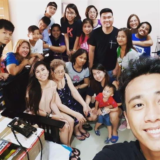 Friends and family enjoy quality time together, engaging in cheerful conversations and smiles.