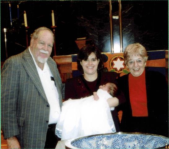 Family members celebrate a baby blessing at a spiritual venue, sharing warmth and smiles.