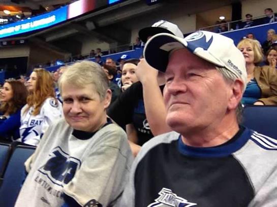 Two enthusiastic fans cheer for their team, showcasing their loyalty and excitement during an event.