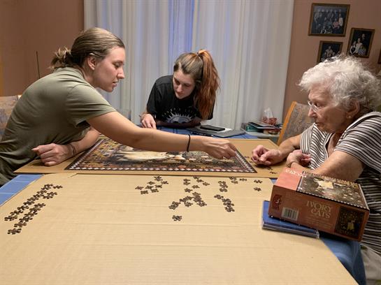 A group of people playing a puzzle