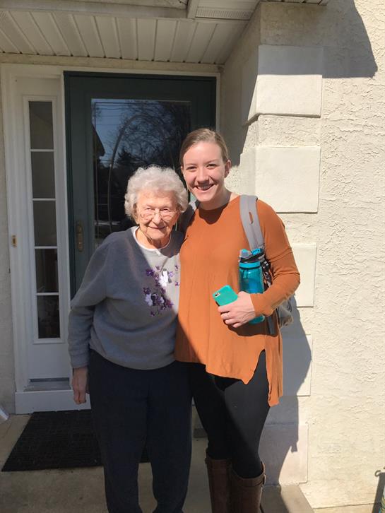 A woman standing next to an older woman