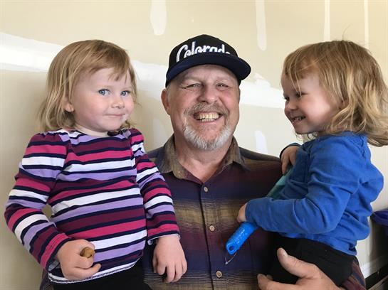 A man holding two children
