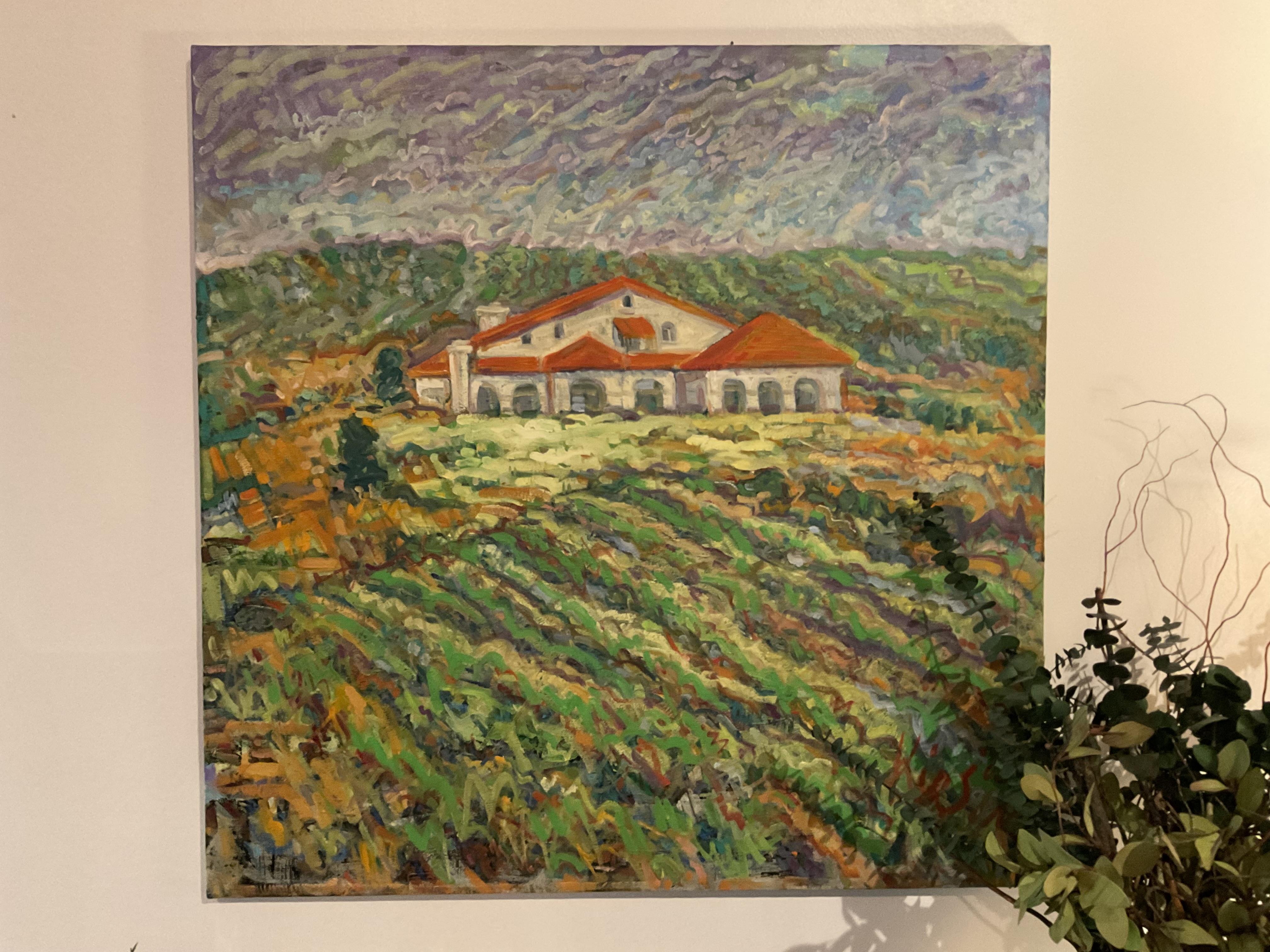 A house stands on a hill with fields all around it. The sky is cloudy, creating a quiet scene.