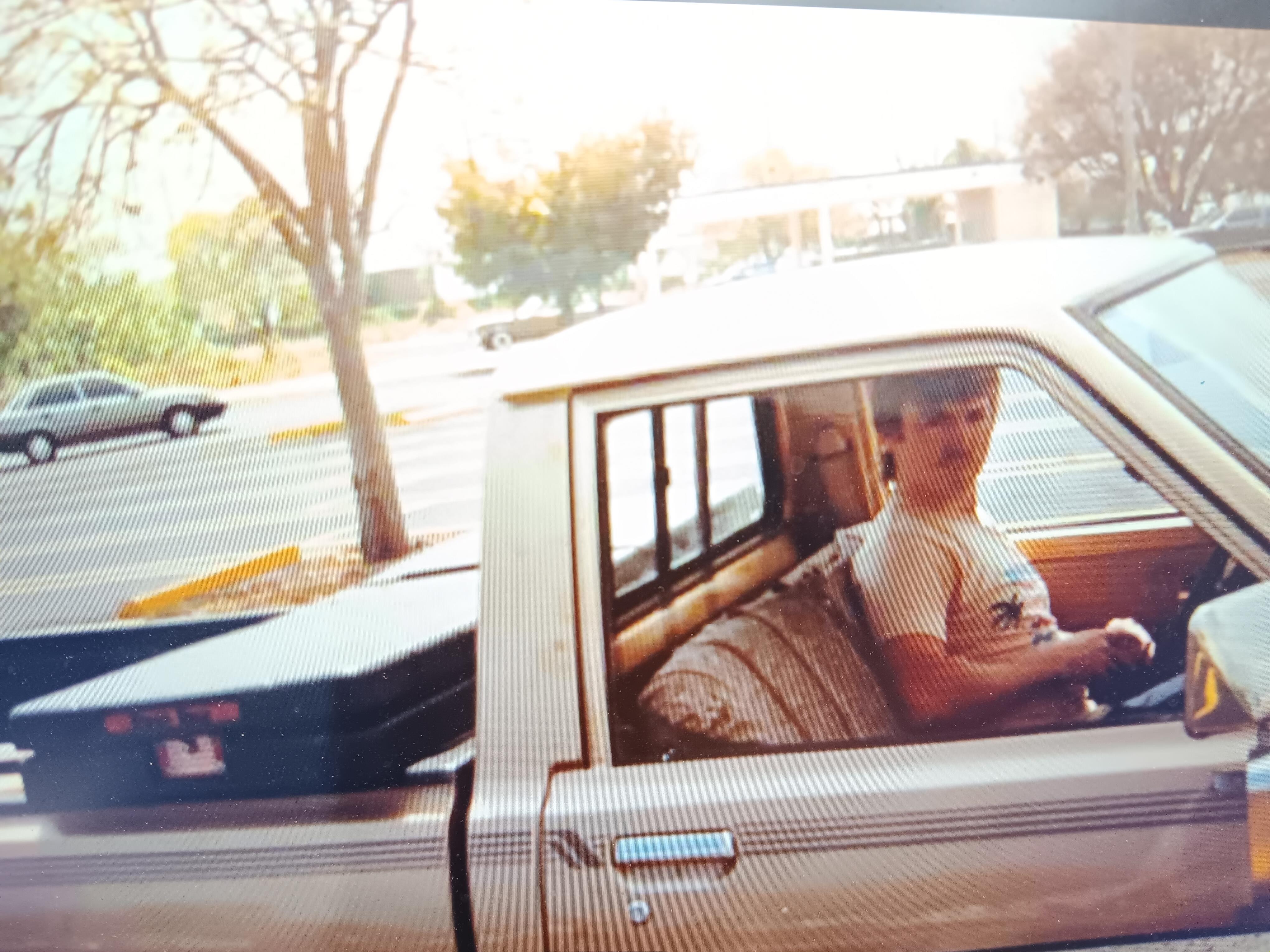 A man sitting in the back of a truck