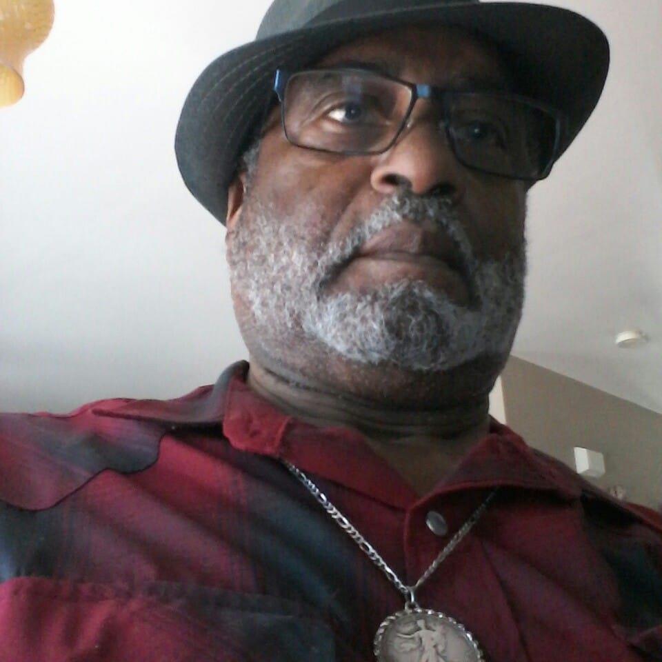 A man wearing a hat and glasses