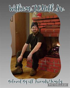 A man sitting on a brick fireplace