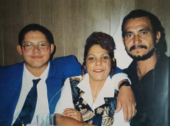 Three friends celebrate together, enjoying each other's company in a lively indoor atmosphere.