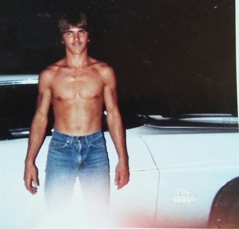 A man standing next to a car