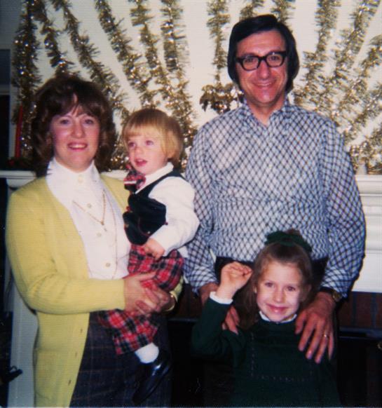 A man and woman holding children