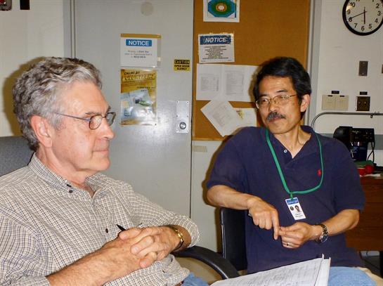 Two professionals converse in an office, sharing ideas and insights while seated.