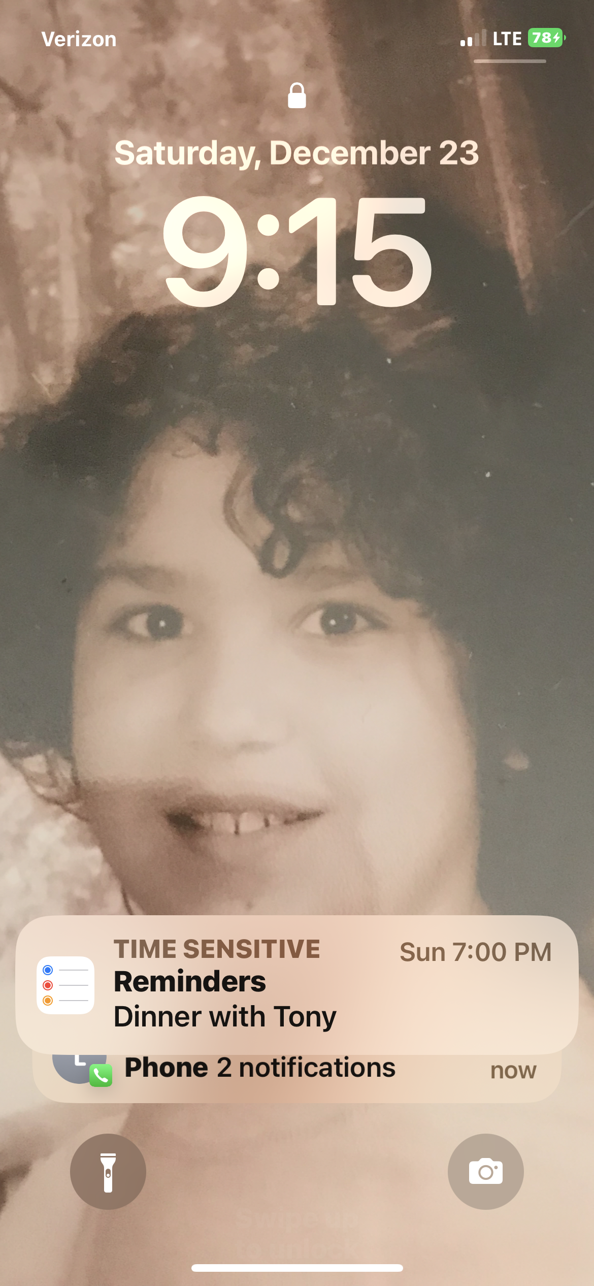 A curly-haired child smiles as dinner plans pop up on the screen.