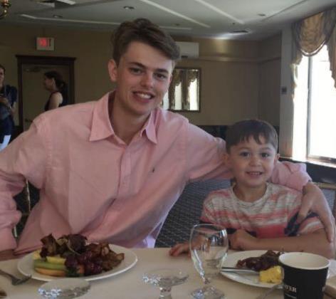 Two people share a joyful moment while dining in a restaurant filled with delicious food.