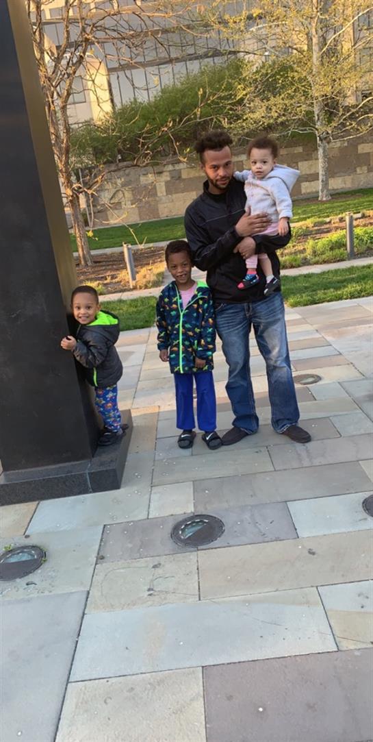 A man holding a baby and a group of children