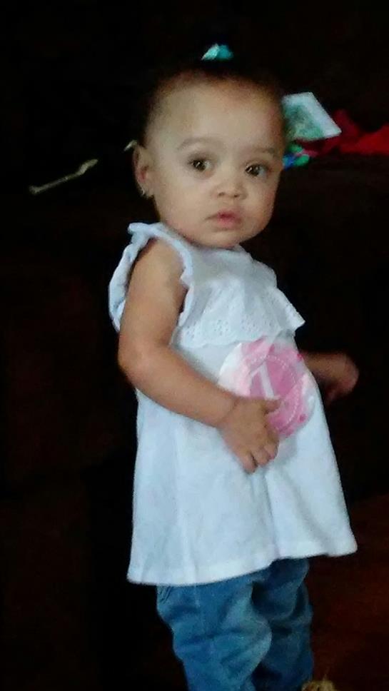 A baby in a white dress