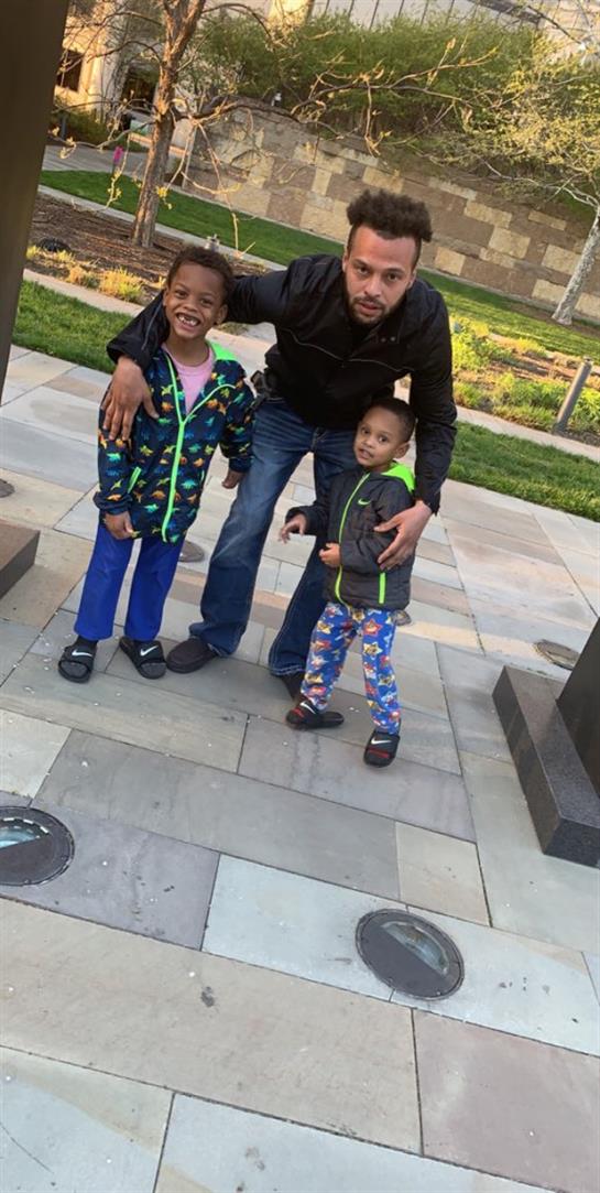 A man and two children posing for a picture