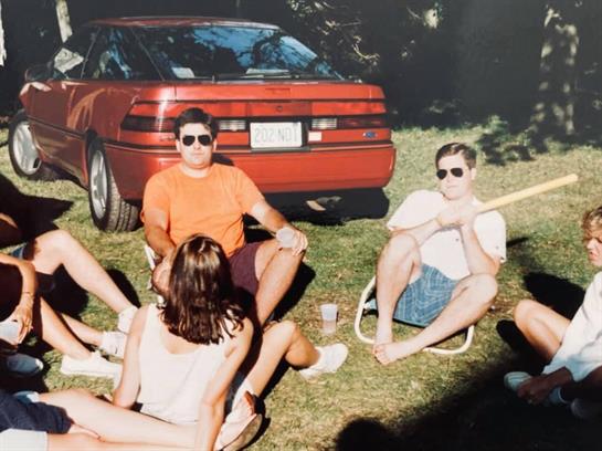 A group of people sitting in grass