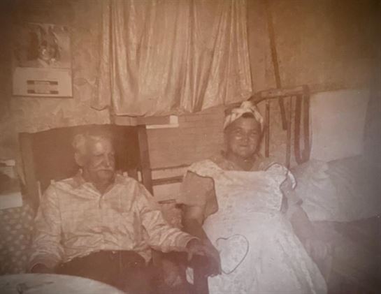 A man and woman sitting in a chair
