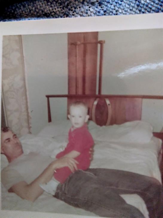 A man lying on a bed with a baby