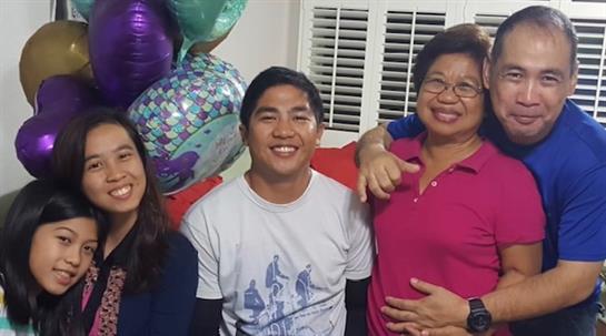 Friends and family gather to celebrate a special occasion with laughter and colorful decorations.