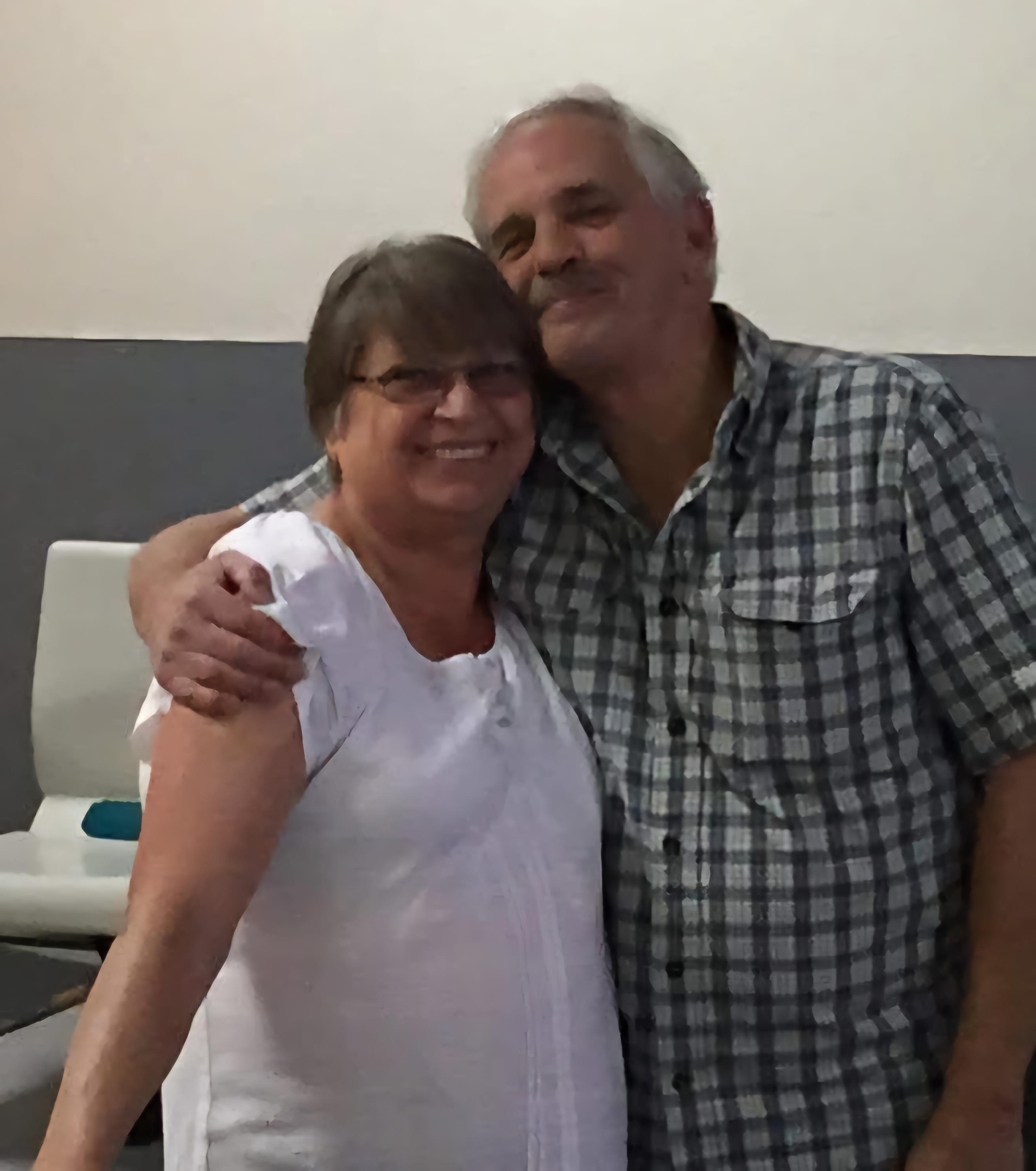 A man and woman posing for a picture