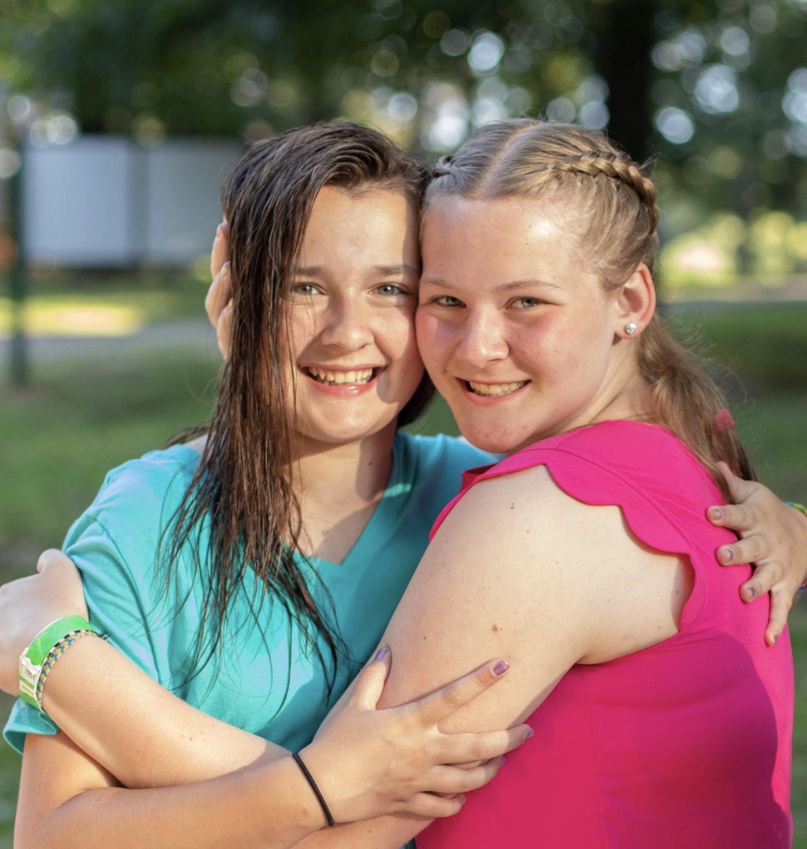 Two girls hugging each other