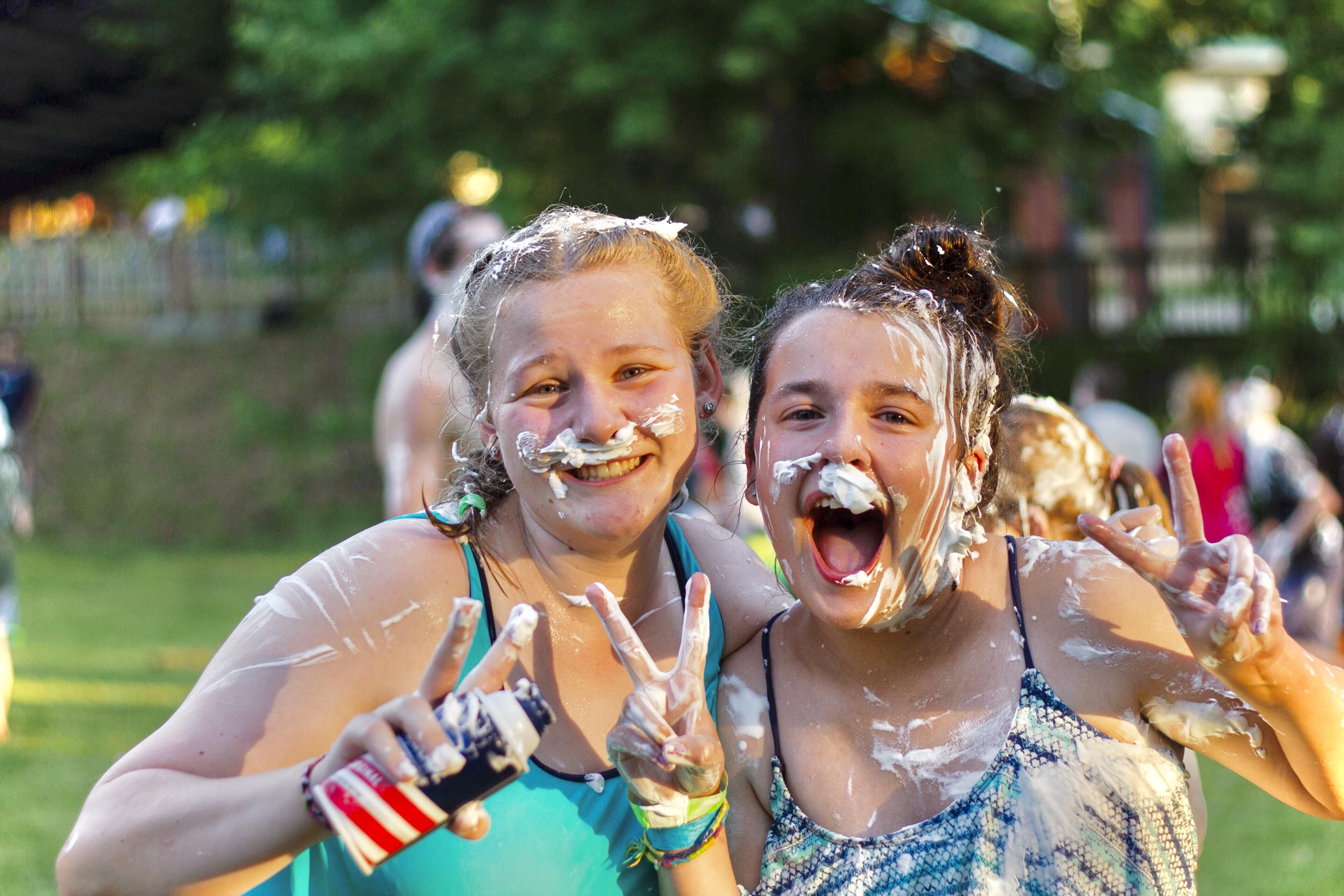 Two women with white cream on their faces