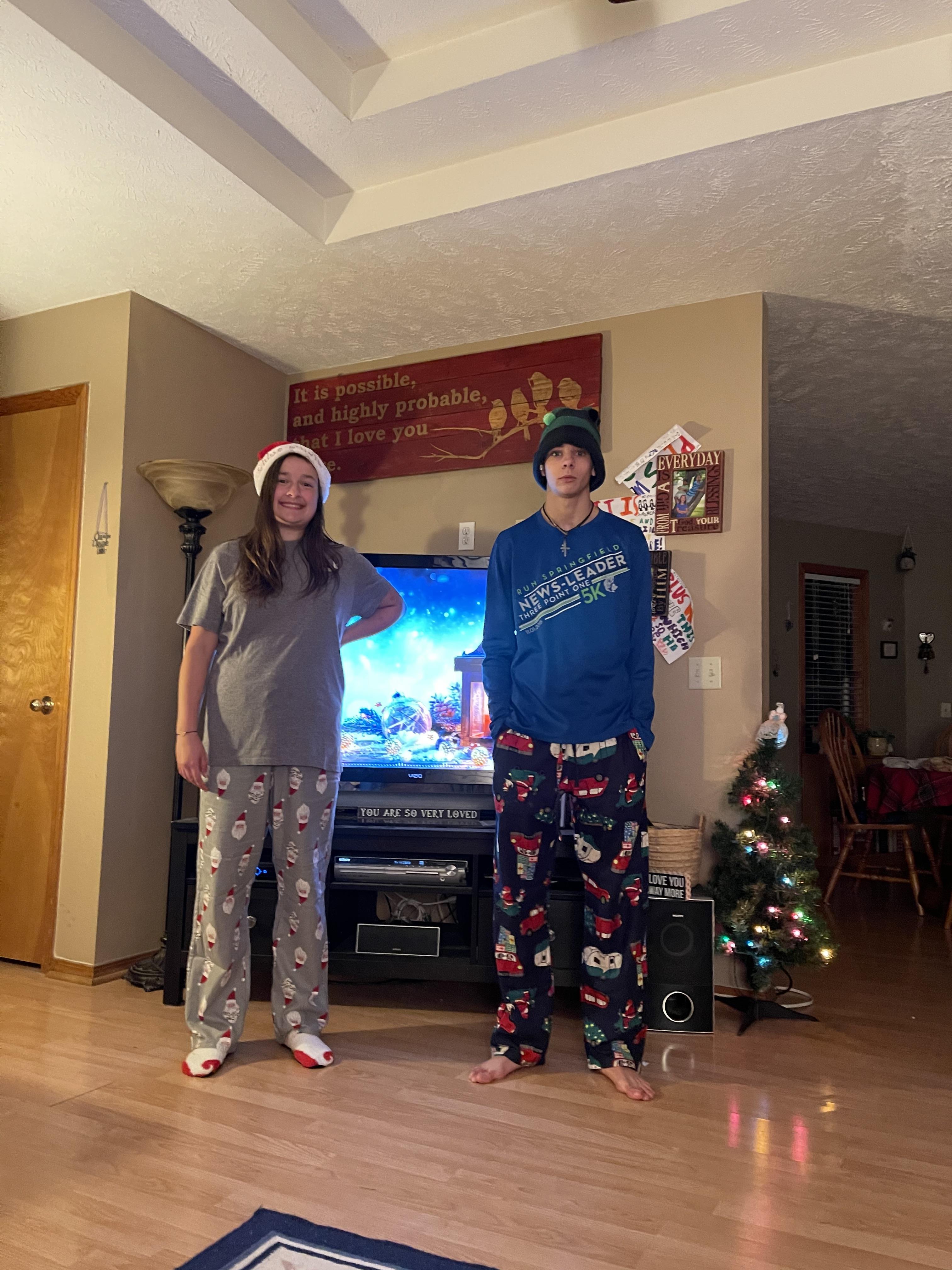Two people standing in front of a television