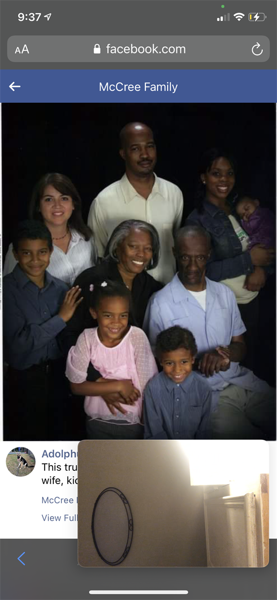 A multigenerational family poses together, highlighting bonds and smiles in a studio.