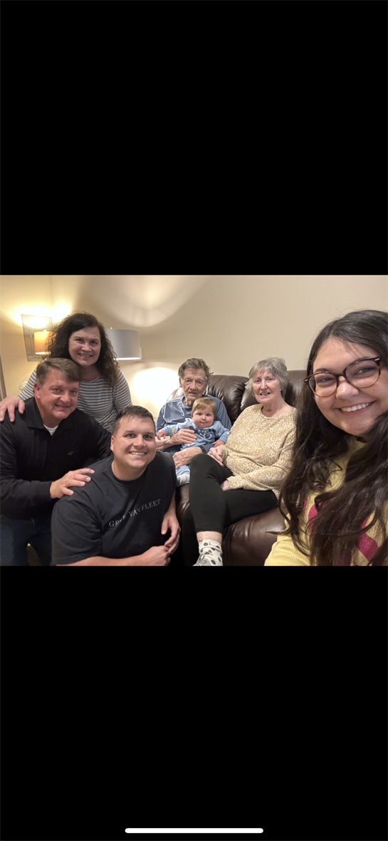 Family members enjoy quality time together in a well-lit living room with a warm atmosphere.