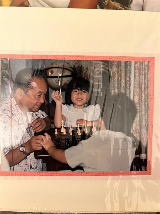 A man and a girl playing chess