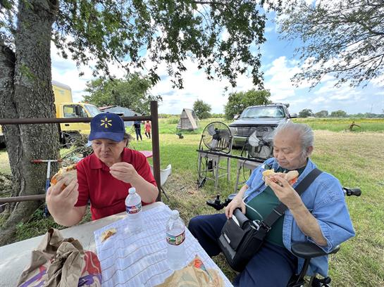 Two women eating at a picnic table
