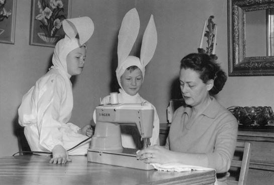 A woman and children wearing bunny ears
