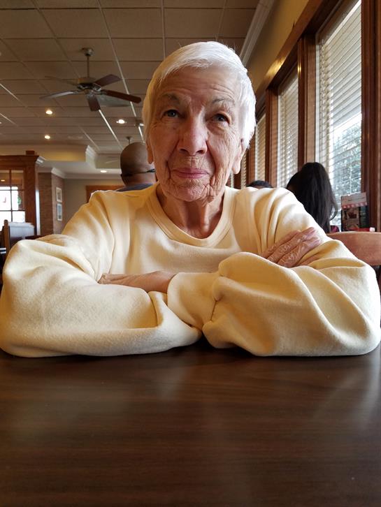 An old woman sitting at a table