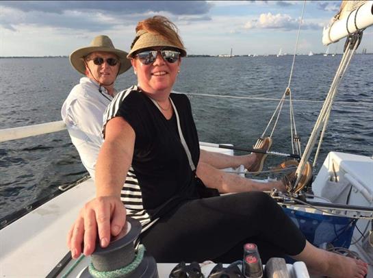 A relaxed sailing experience with friends, enjoying the breeze and beautiful skies over water.